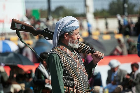 A supporter of Yemen's Houthi rebels carries his rifle during a rally in support of the group, in Sanaa, Yemen, Friday, Oct. 9, 2026. (AP Photo/Osamah Abdulrahman)
