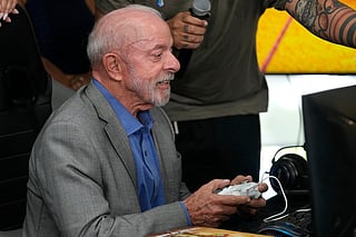 Brazilian President Luiz Inacio Lula da Silva, who is running for reelection, plays a Brazilian video game before a ceremony to sign a decree regulating the video game industry in Brasilia, Brazil, Wednesday, Oct. 14, 2026. (AP Photo/Eraldo Peres)