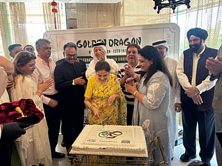 The Bhatia family joins K Muraleedharan (third from left) and guests for Golden Dragon's golden jubilee cake-cutting ceremony.