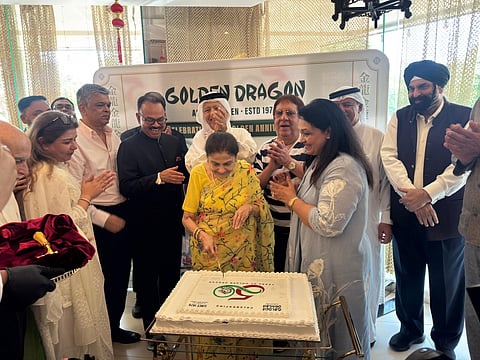 The Bhatia family joins K Muraleedharan (third from left) and guests for Golden Dragon's golden jubilee cake-cutting ceremony.