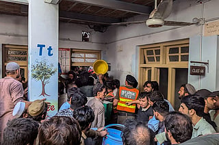 Rescue workers and residents during a search operation after a roof collapsed at a school in Peshawar.