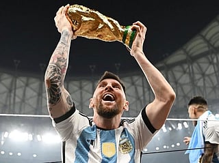 Lionel Messi with FIFA World Cup trophy