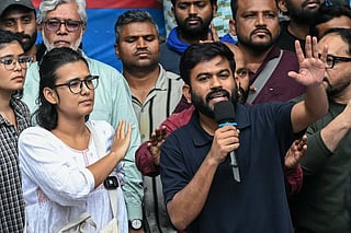 Cockroach Janta Party (CJP) founder Abhijeet Dipke (R) and All India Students' Association (AISA) president Neha Bora (2L) gesture during a press conference in New Delhi on October 15, 2026 amid ongoing protests against India's Chief Election Commissioner Gyanesh Kumar over alleged voter roll irregularities linked to the "special intensive revision" (SIR).