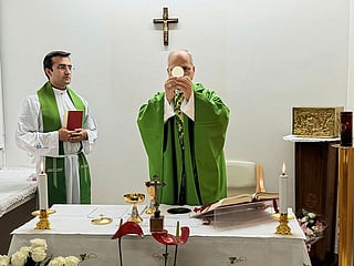 This picture released by Vatican Media on Friday, Oct. 16, 2026, shows Pope Leo XIV, flanked by his personal secretary monsignor Edgard Iván Rimaycuna Inga, left, celebrating Mass at the Agostino Gemelli Polyclinic in Rome where he's recovering after he had a cancer removed from his right lung. 