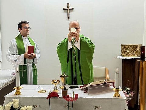This picture released by Vatican Media on Friday, Oct. 16, 2026, shows Pope Leo XIV, flanked by his personal secretary monsignor Edgard Iván Rimaycuna Inga, left, celebrating Mass at the Agostino Gemelli Polyclinic in Rome where he's recovering after he had a cancer removed from his right lung. 