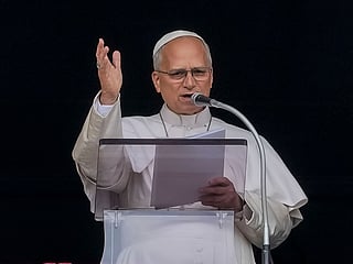 Pope Leo XIV appears at the window of his study in the Apostolic Palace overlooking St. Peter's Square at the Vatican for the traditional noon blessing after praying the Angelus, Sunday, Oct. 18, 2026, a day after he returned from the hospital, where he had lung cancer removed on Tuesday.