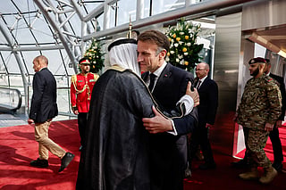 The Emir of Kuwait Sheikh Mishal Al-Ahmad Al-Jaber Al-Sabah greets French President Emmanuel Macron upon his arrival at Kuwait International Airport, in Kuwait City on October 19, 2026.