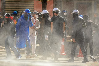 Protesters wear masks during an anti-government demonstration in central Tirana on October 19, 2026, as protests continued for a seventh consecutive day over university conditions and demands for the resignation of Albania's Prime Minister.