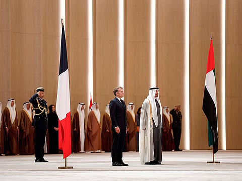 UAE President Sheikh Mohamed bin Zayed Al-Nahyan receives France's President Emmanuel Macron at Zayed International Airport in Abu Dhabi.