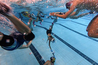 Underwater hockey players take part in the 2026 HKUWHA Under Water Hockey tournament in Hong Kong.
