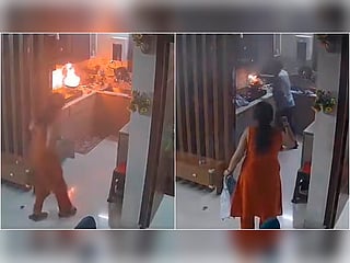 CCTV footage shows a delivery agent helping a doctor after a fire breaks out in her kitchen in Mohali, India.