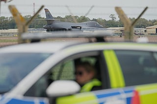 A B1 bomber prepares to take off as police officers guard a checkpoint near RAF Fairford air base, in Fairford, England, Tuesday, Sept. 29, 2026. 