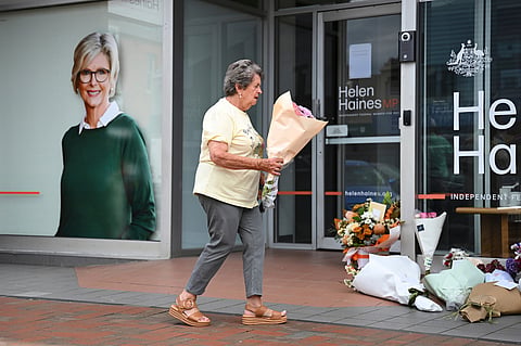 A woman delivers flowers at the electoral office of independent member of parliament, Helen Haines, in Wangaratta, Australia, Tuesday, Oct. 20, 2026. 