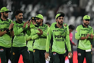 Pakistan's Arafat Minhas (2R) holds the ball after taking his sixth wicket to dismiss England's Adil Rashid as he celebrates with teammates following their victory against England at the end of their one-day international (ODI) tri-series cricket match in the Rawalpindi Cricket Stadium of Rawalpindi on October 20, 2026.