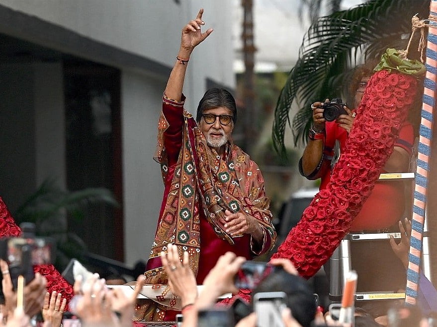 Bollywood actor Amitabh Bachchan gestures to fans gathered to celebrate his 84th birthday outside his residence in Mumbai on October 11, 2026.