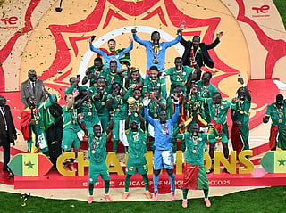 Senegal players celebrate with the trophy after winning the Africa Cup of Nations (CAN) final football match against Morocco at the Prince Moulay Abdellah Stadium in Rabat on January 18, 2026.