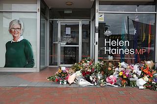 Floral tributes are placed outside the offices of Australian lawmaker Helen Haines who was critically wounded in a "targeted" attack, in Wangaratta on October 21, 2026.
