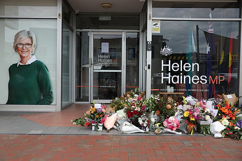 Floral tributes are placed outside the offices of Australian lawmaker Helen Haines who was critically wounded in a "targeted" attack, in Wangaratta on October 21, 2026.
