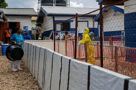A healthcare worker speaks to a colleague at the Ebola treatment center in Beni, North Kivu province, Congo, Monday, Oct. 19, 2026. 