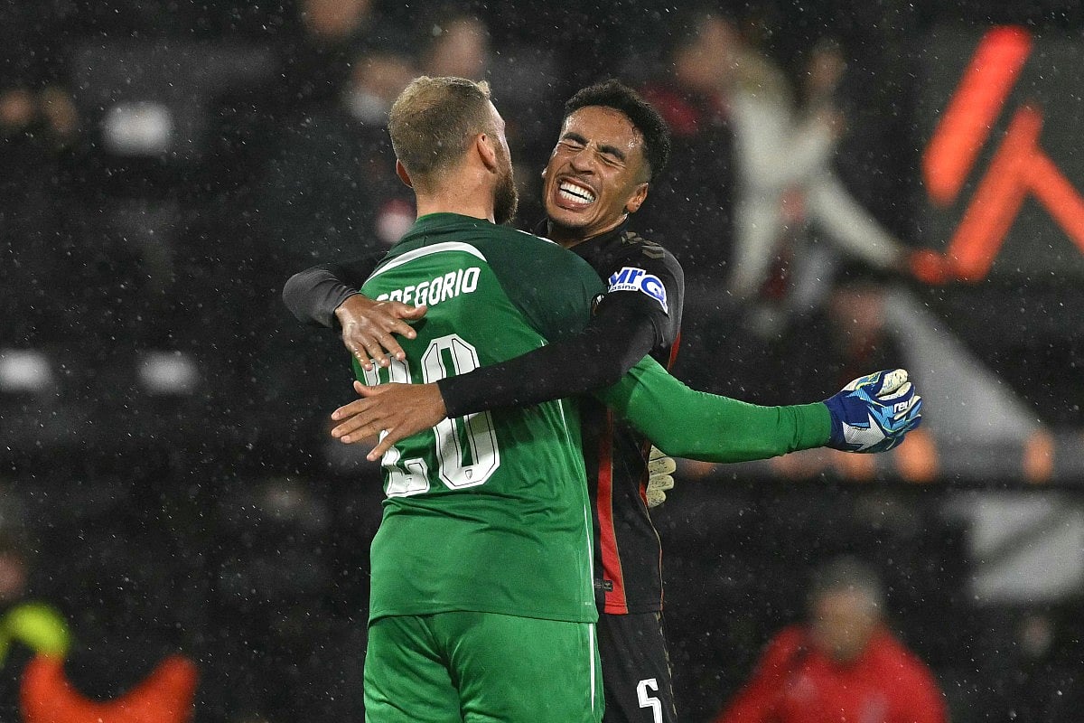 Bournemouth's Italian goalkeeper #20 Michele Di Gregorio celebrates with Bournemouth's English defender #05 James Hill after the UEFA Europa League, league stage football match between Bournemouth and AC Milan Graz at the Vitality Stadium in Bournemouth, southern England on October 22, 2026.