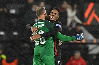 Bournemouth's Italian goalkeeper #20 Michele Di Gregorio celebrates with Bournemouth's English defender #05 James Hill after the UEFA Europa League, league stage football match between Bournemouth and AC Milan Graz at the Vitality Stadium in Bournemouth, southern England on October 22, 2026.