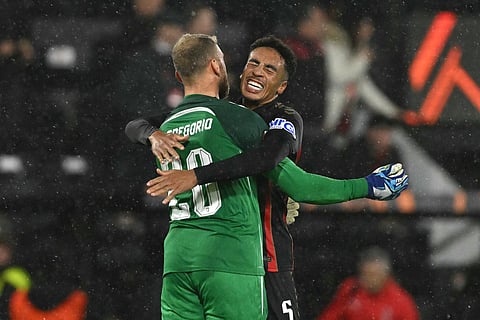 Bournemouth's Italian goalkeeper #20 Michele Di Gregorio celebrates with Bournemouth's English defender #05 James Hill after the UEFA Europa League, league stage football match between Bournemouth and AC Milan Graz at the Vitality Stadium in Bournemouth, southern England on October 22, 2026.