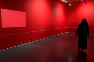 A visitor looks at the empty wall at Raihan Vadra's exhibition, at Bikaner House in New Delhi, Wednesday, Oct. 21, 2026 
