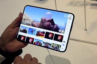 A customer holds the new iPhone Duo on launch day at the Apple Fifth Avenue store in New York on October 23, 2026.