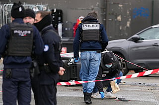 Police officers intervene on a site of a petrol station where a man opened fire from his car, killing one person and injuring four others according to police sources, in Trappes, Paris' suburb on October 23, 2026.