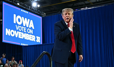 US President Donald Trump gestures during a midterm election campaign rally at Sioux Gateway Airport in Sioux City, Iowa on October 22, 2026.