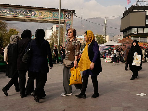 Women walk on a sidewalk at Tajrish Square in Tehran, Iran, on Thursday, October 22, 2026. 