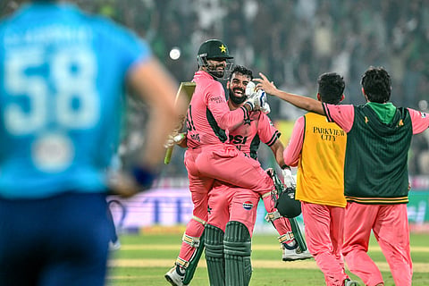 Pakistan's Shadab Khan (2L) and Haris Rauf (L) celebrate after their team's victory in the one-day international (ODI) tri-series cricket match against England at the Gaddafi Stadium in Lahore on October 25, 2026.
