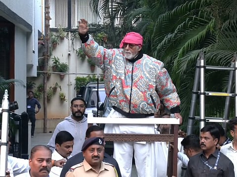 Amitabh Bachchan greets fans outside Jalsa amid heavy security along with Abhishek Bachchan.