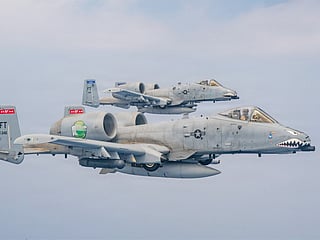 Two US Air Force A-10 aircraft patrol the skies over the Middle East during scheduled daytime flight operations.