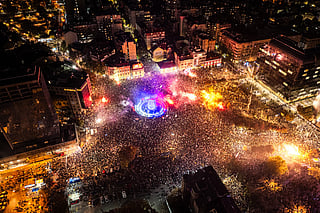 This aerial photograph shows supporters of the Students’ List gathering at Slavija Square as they celebrate their victory a day after Serbia's snap parliamentary elections, in Belgrade on October 26, 2026.