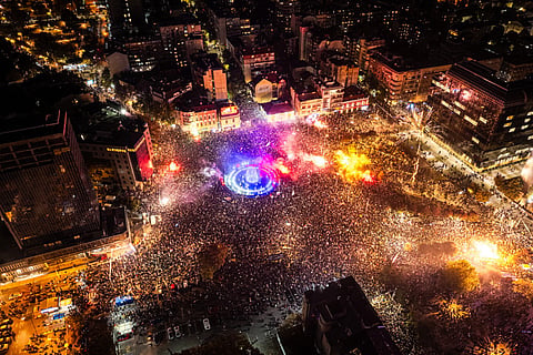 This aerial photograph shows supporters of the Students’ List gathering at Slavija Square as they celebrate their victory a day after Serbia's snap parliamentary elections, in Belgrade on October 26, 2026.