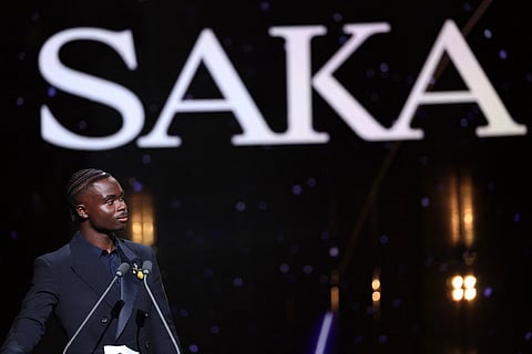 English fooballer Bukayo Saka speaks after being awarded the Socrates Trophy for most involved player in societal and charitable projects during the 2026 Ballon d'Or France Football award ceremony at the Palladium Theatre in London on October 26, 2026.