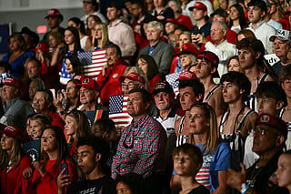 Supporters watch US President Donald Trump speak at a midterm campaign rally at Crossroads Arena in Corinth, Mississippi on October 26, 2026.