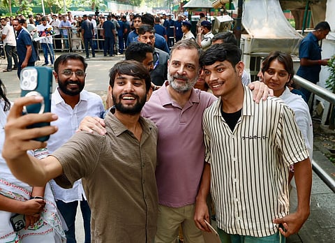 Rahul Gandhi poses for a selfie with protesters during the press conference over the SIR row and the judicial custody of the CJP leaders, in New Delhi  recently.