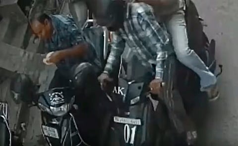 CCTV footage shows a man snatching a bag reportedly containing Rs2 million from a Jaipur businessman as he eats a kachori beside his scooter.