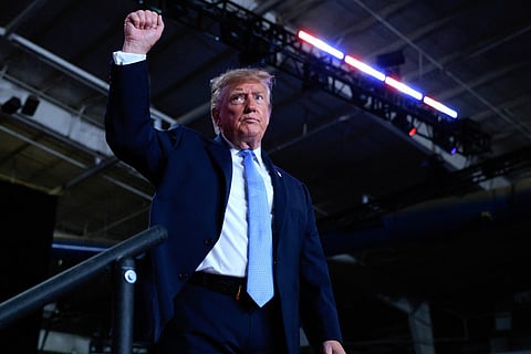 President Donald Trump pumps his fist as he leaves the stage at the conclusion of a campaign rally at Crossroads Arena on October 26, 2026 in Corinth, Mississippi.