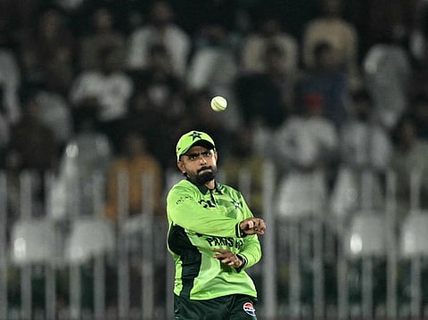 Pakistan's Babar Azam throws the ball during the one-day international (ODI) tri-series cricket match between Pakistan and England at the Rawalpindi Cricket Stadium in Rawalpindi on October 20, 2026.