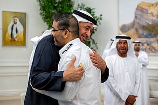 This handout picture provided by the UAE Presidential Court shows UAE President Sheikh Mohamed bin Zayed Al-Nahyan embracing Flydubai pilot Smit Machchhar, during a reception for him and other crew members of Flight 1073 in Abu Dhabi on October 27, 2026.