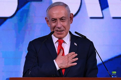Israel's Prime Minister Benjamin Netanyahu addresses his supporters at the election night rally after the first exit polls were announced.