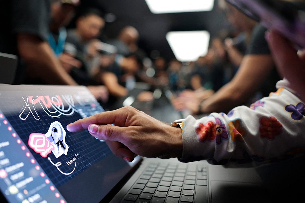 Attendees try out the new touchscreen MacBook Pro at the Apple “Pro and Tell” event on October 28, 2026 in Los Angeles, California.