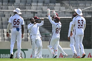 West Indies' Jomel Warrican (2L) celebrates with teammates after taking the wicket of Bangladesh's Mehidy Hasan Miraz during the second day of the first Test against Bangladesh at the Sher-e-Bangla National Stadium in Mirpur on October 29, 2026.