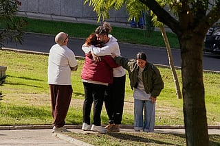 People searching for relatives who were traveling on the trains involved in a collision gather at a religious residence converted into a temporary medical facility in Toledo, Spain.