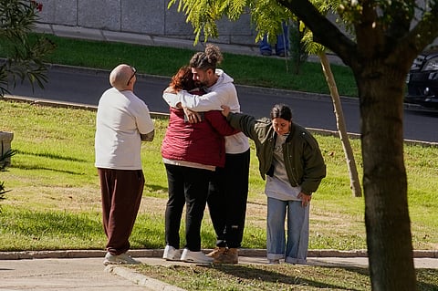 People searching for relatives who were traveling on the trains involved in a collision gather at a religious residence converted into a temporary medical facility in Toledo, Spain.