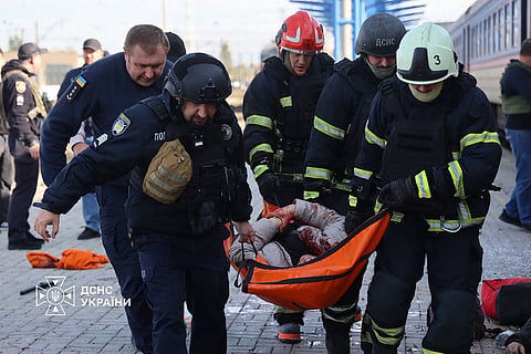 Graphic content / In this handout photograph taken and released by the Ukrainian Emergency Service on October 29, 2026, Ukrainian rescuers carry an injured person on a stretcher following an air attack on the railway station in Dnipro, amid the Russian invasion of Ukraine.