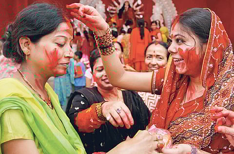 Hindu devotees smear each other with red vermilion as part of Vijaya Dashami rituals in Allahabad on Sunday. Vijaya Dashami, also known as Dasara or Dussehra, is the culmination of the Navratri festival and Durga Puja. 